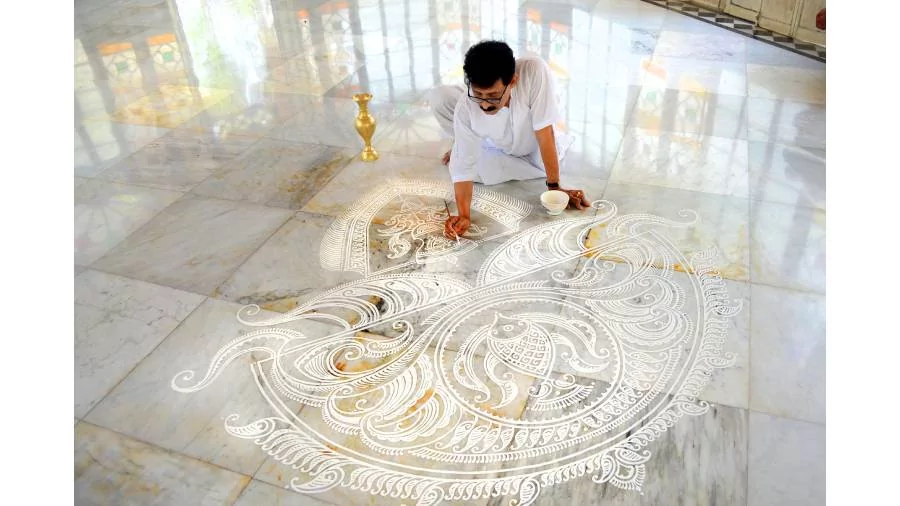 Sudhi Ranjan Mukherjee drawing alpona at Santiniketan